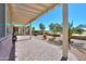 Inviting covered back patio featuring pavers, pergola, and view of the golf course and desert landscaping at 2643 E San Ricardo Trl, Casa Grande, AZ 85194