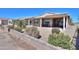 View of a covered back patio surrounded by desert landscaping and a low brick wall at 2643 E San Ricardo Trl, Casa Grande, AZ 85194