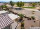 Backyard with patio, desert landscaping, and a lush tree near a bench at 2643 E San Ricardo Trl, Casa Grande, AZ 85194