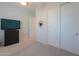 Bedroom features a TV atop a black dresser, carpeted floors and natural light at 2643 E San Ricardo Trl, Casa Grande, AZ 85194