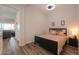 Bedroom with plank floors, neutral walls, ceiling fan and a view into a living space at 2643 E San Ricardo Trl, Casa Grande, AZ 85194