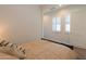 Bedroom features a comfortable bed, bright lighting, and a window with plantation shutters at 2643 E San Ricardo Trl, Casa Grande, AZ 85194