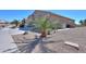 Front yard showcasing a well-maintained desert landscaped yard and attached two-car garage at 2643 E San Ricardo Trl, Casa Grande, AZ 85194