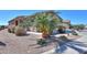 Close up front yard showcasing a well-maintained desert landscaped yard and attached two-car garage at 2643 E San Ricardo Trl, Casa Grande, AZ 85194