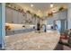 A granite island, stainless steel appliances, and neutral cabinets create a chef-ready kitchen at 2643 E San Ricardo Trl, Casa Grande, AZ 85194