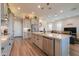 This open-concept kitchen features stainless steel appliances, granite countertops, and light grey cabinetry at 2643 E San Ricardo Trl, Casa Grande, AZ 85194