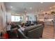 Inviting living room with modern laminate flooring, neutral paint, and seamless flow to kitchen at 2643 E San Ricardo Trl, Casa Grande, AZ 85194
