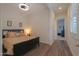 Bedroom with wood-look floors and neutral walls, ceiling fan and a view into the hall at 2643 E San Ricardo Trl, Casa Grande, AZ 85194