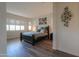 Bright bedroom with natural light, dark wood furniture and plank floors at 2643 E San Ricardo Trl, Casa Grande, AZ 85194