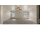 A spacious carpeted bedroom featuring a ceiling fan and natural light from two windows at 2725 W Silver Creek Ln, San Tan Valley, AZ 85144