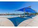 Community pool with tables, chairs and shade structures at 2725 W Silver Creek Ln, San Tan Valley, AZ 85144