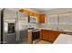 Modern kitchen showcasing stainless steel appliances, wood cabinets, and a double sink with window at 2725 W Silver Creek Ln, San Tan Valley, AZ 85144