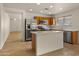Open kitchen featuring stainless steel appliances, an island with a white countertop, and tile floors at 2725 W Silver Creek Ln, San Tan Valley, AZ 85144