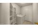 Bright laundry room featuring built-in shelving, tiled floor, and washer and dryer hookups at 2725 W Silver Creek Ln, San Tan Valley, AZ 85144