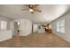 Open concept living space with ceiling fans, tile flooring, and view into the kitchen at 2725 W Silver Creek Ln, San Tan Valley, AZ 85144