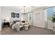 Inviting bedroom with a plush bed, stylish chandelier, and neutral color palette at 28200 N Nealite Dr, San Tan Valley, AZ 85143