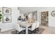 Bright dining area featuring a modern table, white chairs, and stylish decor at 28200 N Nealite Dr, San Tan Valley, AZ 85143