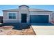 Charming single-story home with neutral stucco, a gray roof, a spacious garage, and desert landscaping at 28200 N Nealite Dr, San Tan Valley, AZ 85143