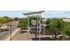 Community sign surrounded by lush trees in front of a modern building at 28200 N Nealite Dr, San Tan Valley, AZ 85143