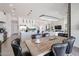 Open-concept space features a wooden dining table with black chairs adjacent to kitchen and living room at 28282 N 158Th St, Scottsdale, AZ 85262