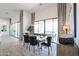 Modern dining room with natural light, wood table, stylish decor, and view to the outdoor pool area at 28282 N 158Th St, Scottsdale, AZ 85262