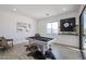Well-lit game room with a pool table, stylish decor, and sliding doors to the patio at 28282 N 158Th St, Scottsdale, AZ 85262
