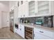 Contemporary kitchen featuring white cabinets, stainless steel appliances, a wine fridge, and sleek countertops at 28282 N 158Th St, Scottsdale, AZ 85262