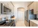 Galley kitchen with stainless steel appliances and stylish grey cabinets at 29510 N 244Th Dr, Wittmann, AZ 85361