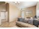 Cozy living room featuring a comfortable sofa with decorative pillows, tile flooring, and lots of natural light at 3734 W Blue Eagle Ct, Phoenix, AZ 85086