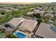 Expansive aerial view of a beautiful home featuring a private pool, lush landscaping, and a serene neighborhood setting at 4088 E Comstock Dr, Gilbert, AZ 85296