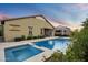 Beautiful backyard with a sparkling pool, spa, and mature landscaping, creating a private oasis at 4088 E Comstock Dr, Gilbert, AZ 85296