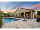 Beautiful backyard oasis featuring a sparkling pool, covered patio, and ample space for entertaining at 4088 E Comstock Dr, Gilbert, AZ 85296