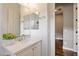 Well-lit bathroom with white cabinets, quartz counters, and a view into the tile shower at 4088 E Comstock Dr, Gilbert, AZ 85296