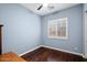 Comfortable bedroom with hardwood floors, plantation shutters, and a ceiling fan at 4088 E Comstock Dr, Gilbert, AZ 85296