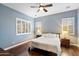 Serene bedroom with hardwood floors, plantation shutters, and neutral wall paint at 4088 E Comstock Dr, Gilbert, AZ 85296