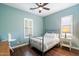 Comfortable bedroom featuring a stylish metal bed frame and soothing light blue walls at 4088 E Comstock Dr, Gilbert, AZ 85296