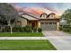 Charming single-story home with a well-manicured lawn and a two-car garage under a sunset sky at 4088 E Comstock Dr, Gilbert, AZ 85296