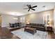 Spacious living room with hardwood floors, modern fan, decorative rug and comfortable seating at 4088 E Comstock Dr, Gilbert, AZ 85296