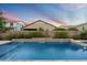 Tranquil pool area featuring cascading waterfalls and lush landscaping for a peaceful retreat at 4088 E Comstock Dr, Gilbert, AZ 85296