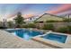 Relaxing pool area with travertine tile and water features at 4088 E Comstock Dr, Gilbert, AZ 85296