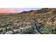 Panoramic aerial view of a desert community nestled in the mountains with lush landscaping and winding roads at 41711 N Pinion Hills Ct, Anthem, AZ 85086