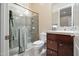 Bright bathroom features a glass shower, sink with vanity, toilet, and neutral color palette at 41711 N Pinion Hills Ct, Anthem, AZ 85086