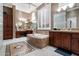 Elegant bathroom featuring a large soaking tub, dual vanities, and decorative tile flooring at 41711 N Pinion Hills Ct, Anthem, AZ 85086