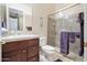 Well-lit bathroom featuring a glass shower, sink with vanity, and neutral color palette at 41711 N Pinion Hills Ct, Anthem, AZ 85086