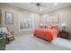 Comfortable bedroom featuring a ceiling fan, shutters, and decoratively appointed lamps and artwork at 41711 N Pinion Hills Ct, Anthem, AZ 85086