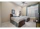 Shared bedroom with twin beds, neutral color palette, and shuttered window at 41711 N Pinion Hills Ct, Anthem, AZ 85086
