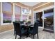 An elegant dining room with modern lighting and desert sunset views at 41711 N Pinion Hills Ct, Anthem, AZ 85086