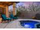Cozy outdoor hot tub with lounge chairs and desert views at twilight at 41711 N Pinion Hills Ct, Anthem, AZ 85086