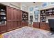 Spacious office boasting custom built-ins, hardwood flooring, and golf-themed decor at 41711 N Pinion Hills Ct, Anthem, AZ 85086