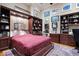 Murphy bed concealed by custom cabinetry in office with hardwood floors and decor at 41711 N Pinion Hills Ct, Anthem, AZ 85086